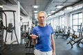 Confident senior man holding dumbbell in gym Royalty Free Stock Photo
