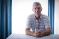 Portrait of confident senior man in living room Royalty Free Stock Photo