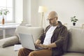 Portrait of confident serious and focused casual businessman working remotely at home. Royalty Free Stock Photo