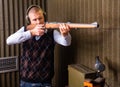 Confident shooter sighting in or zeroing shotgun in shooting gallery Royalty Free Stock Photo