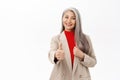 Portrait of confident smiling asian businesswoman, senior lady in suit showing thumb up in approval, recommending Royalty Free Stock Photo