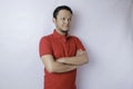 Portrait of a confident smiling Asian man standing with arms folded and looking at the camera isolated over white background Royalty Free Stock Photo