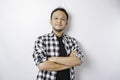 Portrait of a confident smiling Asian man wearing tartan shirt standing with arms folded and looking at the camera isolated over Royalty Free Stock Photo