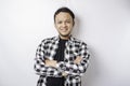 Portrait of a confident smiling Asian man wearing tartan shirt standing with arms folded and looking at the camera isolated over Royalty Free Stock Photo