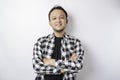 Portrait of a confident smiling Asian man wearing tartan shirt standing with arms folded and looking at the camera isolated over Royalty Free Stock Photo