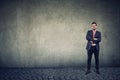 Confident smiling business man standing against a wall background Royalty Free Stock Photo