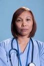 Portrait of confident specialist nurse with stethoscope waiting to attend visit checkup