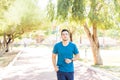 Confident Sportsman Jogging In Park On Sunny Day