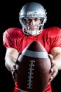 Portrait of confident sportsman showing American football