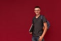 Portrait of a confident student guy with a backpack and laptop Royalty Free Stock Photo