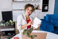 Portrait of confident stylish business woman is making notes, looking at the camera, smiling. Successful young female Royalty Free Stock Photo