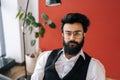 Portrait of confident successful Indian business man in elegant formalwear posing coworking office by window. Bearded Royalty Free Stock Photo