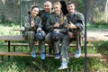 Portrait of confident team of paintball players with marker guns outdoors Royalty Free Stock Photo