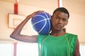 Portrait of confident teenage boy holding basketball Royalty Free Stock Photo