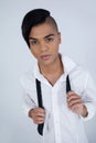 Portrait of confident transgender woman holding tie