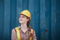 Portrait of Confident Transport Engineer Woman in Safety Equipment Standing in Container Ship Yard. Transportation Engineering