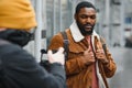 portrait of confident trendy serious african guy in stylish outfit, young afro american male posing at camera, looking Royalty Free Stock Photo