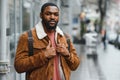 portrait of confident trendy serious african guy in stylish outfit, young afro american male posing at camera, looking Royalty Free Stock Photo