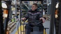 Portrait of confident warehouse loader operator driving autoloader waving greeting colleague in industrial storage