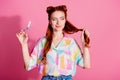 Portrait of confident woman wear print shirt look at foxy curl hold scissors making tail shorter isolated on pink color Royalty Free Stock Photo