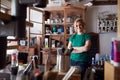 Portrait Of Confident Woman Working In Workshop On Upcycling And Craft Projects