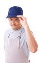 Portrait of confident worker, employee with blue cap and apron