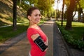 Portrait of a confident 40 years old African American woman in sportswear standing in forest city park with her arms crossed and Royalty Free Stock Photo