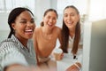 Portrait of a confident young african american business woman taking selfies with her colleagues in an office. Group of Royalty Free Stock Photo