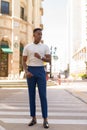 Full length shot of young African businessman outdoors walking over crosswalk Royalty Free Stock Photo