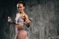 Portrait of confident young athletic woman with perfect beautiful body wearing activewear doing exercise with lifting Royalty Free Stock Photo
