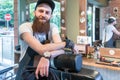 Portrait of a confident young barber smiling in a vintage beauty salon