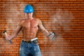 Portrait of confident young beautiful handyman with tools on the background wall. Royalty Free Stock Photo