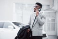 Portrait of a confident young businessman walking in the city talking on cell phone Royalty Free Stock Photo