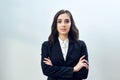 portrait of a confident young businesswoman entrepreneur folded arms wearing black jacket on a white background Royalty Free Stock Photo