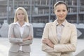 Portrait of confident young businesswomen standing arms crossed outdoors Royalty Free Stock Photo