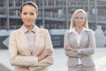 Portrait of confident young businesswomen standing arms crossed outdoors Royalty Free Stock Photo