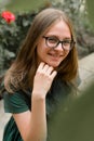 Portrait of confident young girl with eyeglasses, smiling. Blonde hair, natural, beautiful teen age girl. Summer portrait Royalty Free Stock Photo