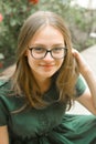 Portrait of confident young girl with eyeglasses, smiling. Blonde hair, natural, beautiful teen age girl. Summer portrait Royalty Free Stock Photo