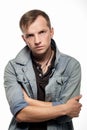 Portrait of a confident young man in jeans jacket on a white Royalty Free Stock Photo