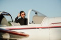 Portrait of confident young man pilot in small plane Royalty Free Stock Photo