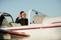 Portrait of confident young man pilot in small plane Royalty Free Stock Photo