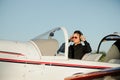 Portrait of confident young man pilot in small plane Royalty Free Stock Photo