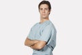Portrait of confident young man in surgical scrubs standing against gray background Royalty Free Stock Photo