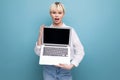 portrait of confident young pretty blond business woman in white blouse demonstrating project on laptop screen with Royalty Free Stock Photo