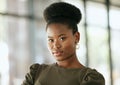 Portrait of a confident young professional african american business woman standing in an office and looking at camera Royalty Free Stock Photo