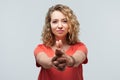 Portrait of Confident young woman holding hands like gun. Studio shot, white background Royalty Free Stock Photo