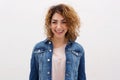 Confident young woman with curly hair smiling abasing white background