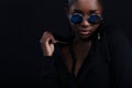 Confident and cool woman with dark skin wearing round sunglasses Royalty Free Stock Photo