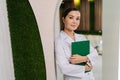 Portrait of confident young woman doctor or nurse in medical coat holding clipboard with with medical report standing Royalty Free Stock Photo