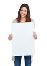 Happy to get behind your idea. Portrait of a confident young woman holding a blank white sign in studio. Royalty Free Stock Photo